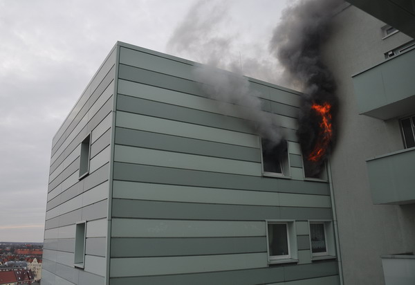 Flammen schlagen aus der Brandwohnung