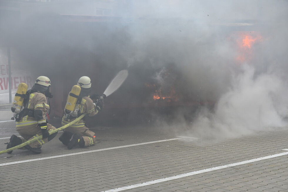 Die Feuerwehr ist vor Ort und beginnt die Brandbekämpfung.