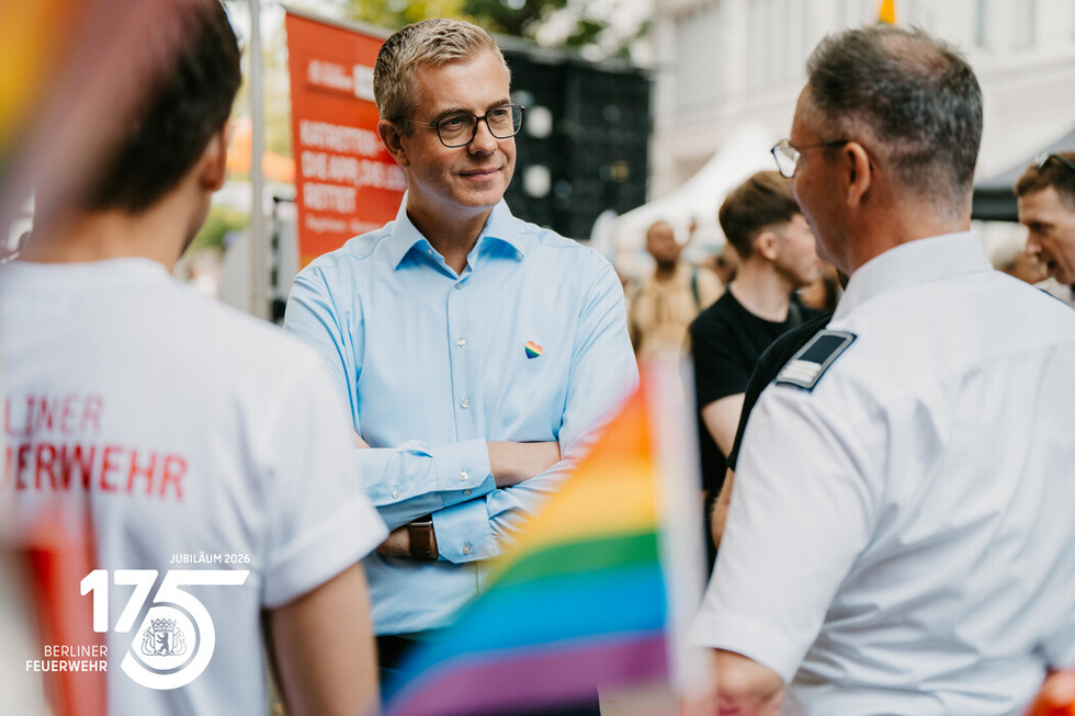 Mitarbeitende der Berliner Feuerwehr im Austausch mit dem Berliner Senator für Finanzen, Stefan Evers, am Informationsstand der Berliner Feuerwehr.