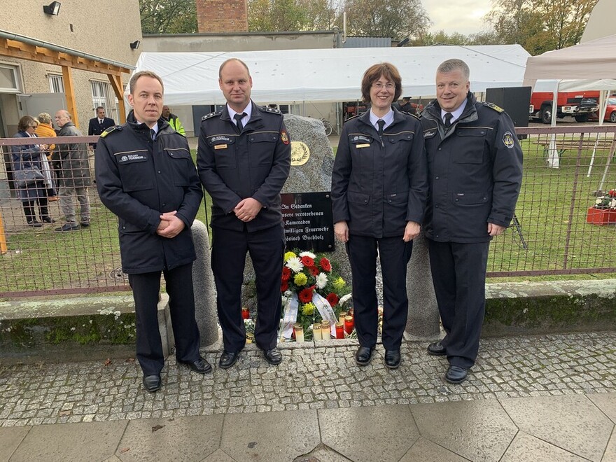 Leiter der Direktion Nord Kleist, Wehrleiter Rathenow, Feuerwehrpfarrerin Röhm und Landesbranddirektor Dr. Homrighausen vor dem eingeweihten Gedenkstein