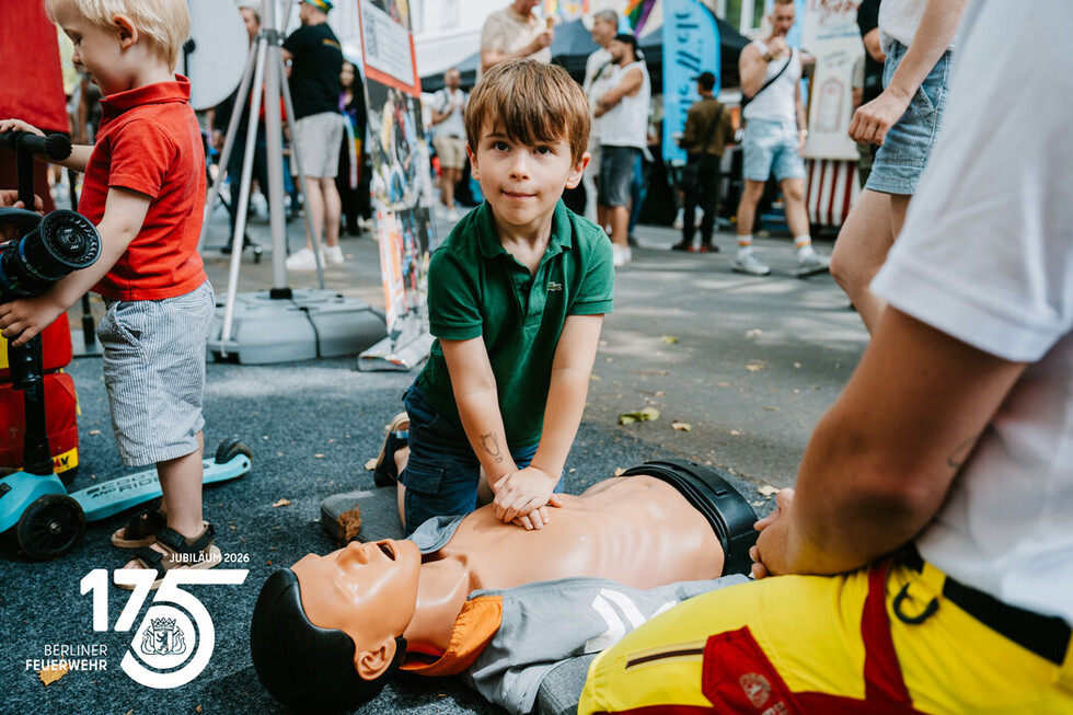 Mitarbeitende der Berliner Feuerwehr zeigen Besucherinnen und Besuchern die Grundlagen der Herzdruckmassage.